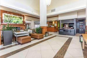 a lobby of a hotel with a restaurant at Hilton Garden Inn Chicago/Tinley Park in Tinley Park