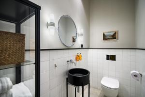 a bathroom with a toilet and a mirror at Rezident Tomis Marina in Constanţa