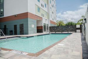 a swimming pool in front of a building at Hilton Garden Inn Tampa Suncoast Parkway in Lutz