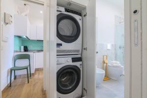 a laundry room with a washer and dryer at Contempora Apartments - bilocale Washington 105 in Milan