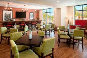 a restaurant with tables and chairs and a bar at Hampton Inn Kanab in Kanab