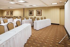 a conference room with rows of tables and chairs at Hampton Inn & Suites Chicago/Saint Charles in Saint Charles