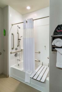 a bathroom with a shower and a bath tub at Hampton Inn & Suites Portland/Vancouver in Vancouver