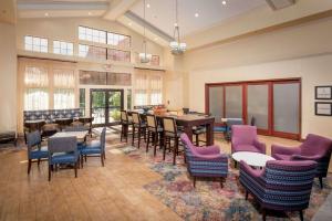 a large room with chairs and tables and a dining room at Hampton Inn & Suites Binghamton/Vestal in Vestal