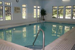 a swimming pool in a building with windows at Hampton Inn & Suites Binghamton/Vestal in Vestal