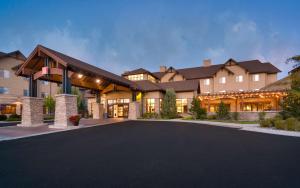 a large house with a driveway in front of it at Hilton Garden Inn Bozeman in Bozeman