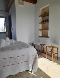 a bedroom with a bed and a table in it at Olive Tree Suites Farmstay Villa in Lamporecchio