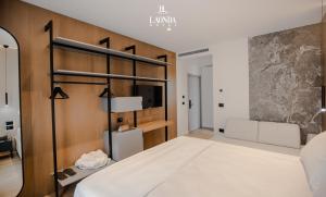 a bedroom with a bed and a tv at La Onda Hotel Durres in Durrës