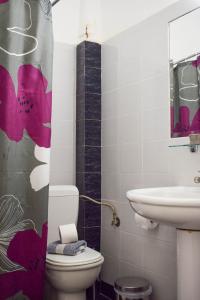 a bathroom with a toilet and a sink at City Center Hotel in Kalamata