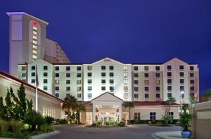 un hotel con un grande edificio bianco con torre dell'orologio di Hilton Pensacola Beach a Pensacola Beach