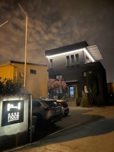 a car parked in front of a building at night at Noce Zagreb in Zagreb