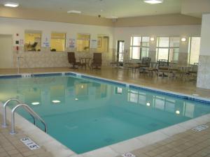 a large pool with blue water in a building at Homewood Suites by Hilton Brighton in Brighton