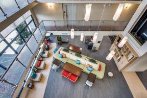 an overhead view of a living room with a couch and chairs at Home2 Suites by Hilton DFW Airport South Irving in Irving