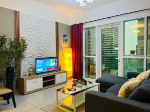 a living room with a couch and a tv at SKY NEST HOLIDAY HOMES 1 bedroom Apartment dubai marina 2903 in Dubai