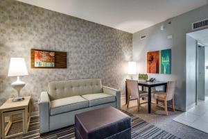 a living room with a couch and a table at Home2 Suites by Hilton DFW Airport South Irving in Irving