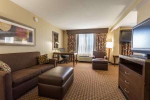 a living room with a couch and a flat screen tv at Hilton Garden Inn San Mateo in San Mateo