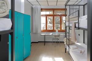 a dorm room with a desk and bunk beds at Plus Florence in Florence