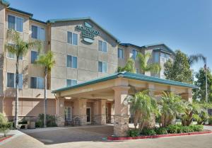 a hotel building with palm trees in front of it at Homewood Suites by Hilton San Diego-Del Mar in San Diego