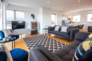 a living room with a couch and a fireplace at Howells Mere 27, Crane Lodge in Somerford Keynes