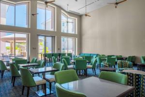 a room with tables and chairs and windows at Homewood Suites by Hilton Phoenix Airport South in Phoenix