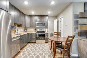 a kitchen with wooden cabinets and a table and chairs at Cozy Covington Studio Rental Near Historic Square! in Covington