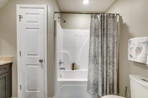 a bathroom with a tub and a shower curtain at Cozy Covington Studio Rental Near Historic Square! in Covington