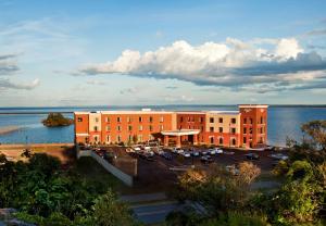 a building with a parking lot next to a body of water at Hampton Inn Marquette-Waterfront in Marquette