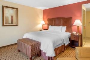 a hotel room with a large bed and a chair at Hampton Inn & Suites Arcata in Arcata