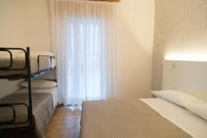 Ένα ή περισσότερα κρεβάτια σε δωμάτιο στο Albergo Conca d'Oro