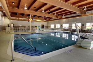 a large swimming pool in a large building at Hampton Inn & Suites Chicago/Aurora in Aurora