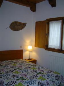 a bedroom with a bed with a leaf on the wall at Casa do Pinto in Arouca