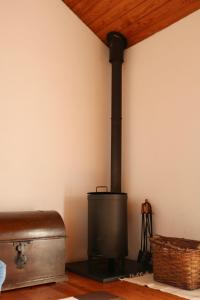 a stove in the corner of a room at Casa da Eira in Marco de Canavezes