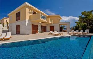 a house with a swimming pool in front of a house at Villa Harmony 1 in Hvar