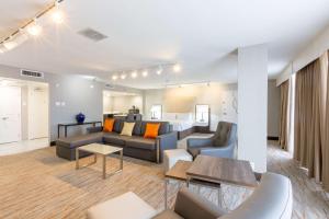 a living room with a couch and a table at DoubleTree by Hilton Dallas/Richardson in Richardson