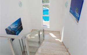 a staircase in a white room with a glass railing at Villa Marko in Tribunj
