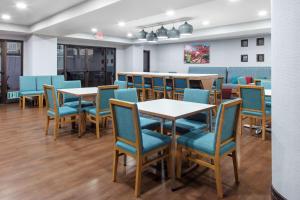 a dining room with tables and blue chairs at Hampton Inn Las Vegas/Summerlin in Las Vegas