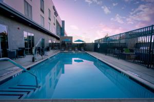 a swimming pool in front of a building at Home2 Suites By Hilton Riverside March Air Force Base, Ca in Riverside