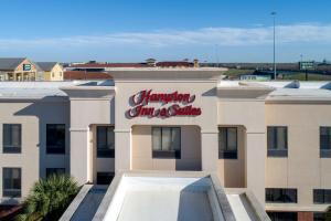 a sign for a hampton inn and suites on a building at Hampton Inn & Suites Port Arthur in Port Arthur