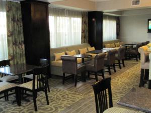 a restaurant with tables and chairs and a couch at Hampton Inn Lindale/Tyler in Lindale