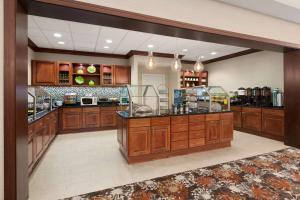 a large kitchen with wooden cabinets and a counter at Homewood Suites Medford in Medford