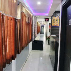 a hallway in a building with orange curtains at Hotel Long Stay in Ahmedabad