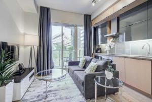 a living room with a couch and a kitchen at Residence Inn by Soho in Toronto