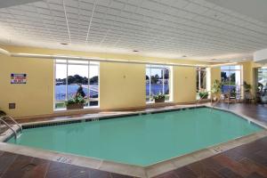 a swimming pool in a large room with a large ceiling at Hilton Philadelphia City Avenue in Philadelphia
