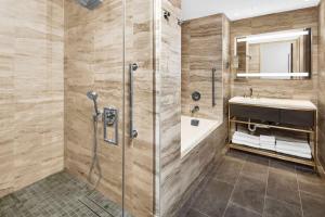 a bathroom with a shower and a sink at Hilton Club The Central at 5th New York in New York