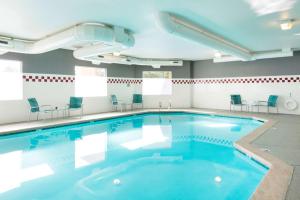 a swimming pool in a room with chairs at DoubleTree by Hilton Vancouver in Vancouver