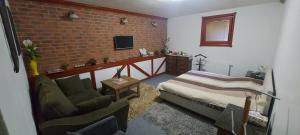 a bedroom with a bed and a brick wall at Apartment v historickom centre in Bardejov