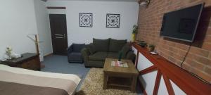 a living room with a couch and a tv at Apartment v historickom centre in Bardejov