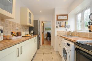 a kitchen with a sink and a dishwasher at Weasels Nest in Bodmin