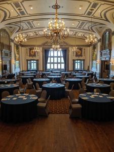 a banquet hall with blue tables and chairs at The Tudor Arms Hotel Cleveland - a DoubleTree by Hilton in Cleveland
