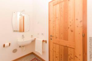 a bathroom with a sink and a mirror at Lovely apt in Pinzolo Val Rendena 7 in Pinzolo +28 photos